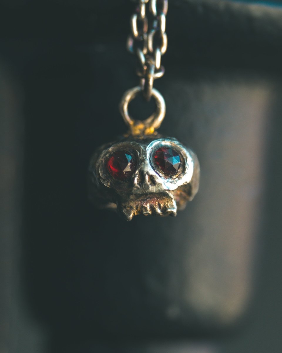 Memento Mori Skull Charm with Almandine Garnet Eyes – Sterling Silver & 23.5K Gold | Talisman of Life, Death, and Deep Transformation - Machinations