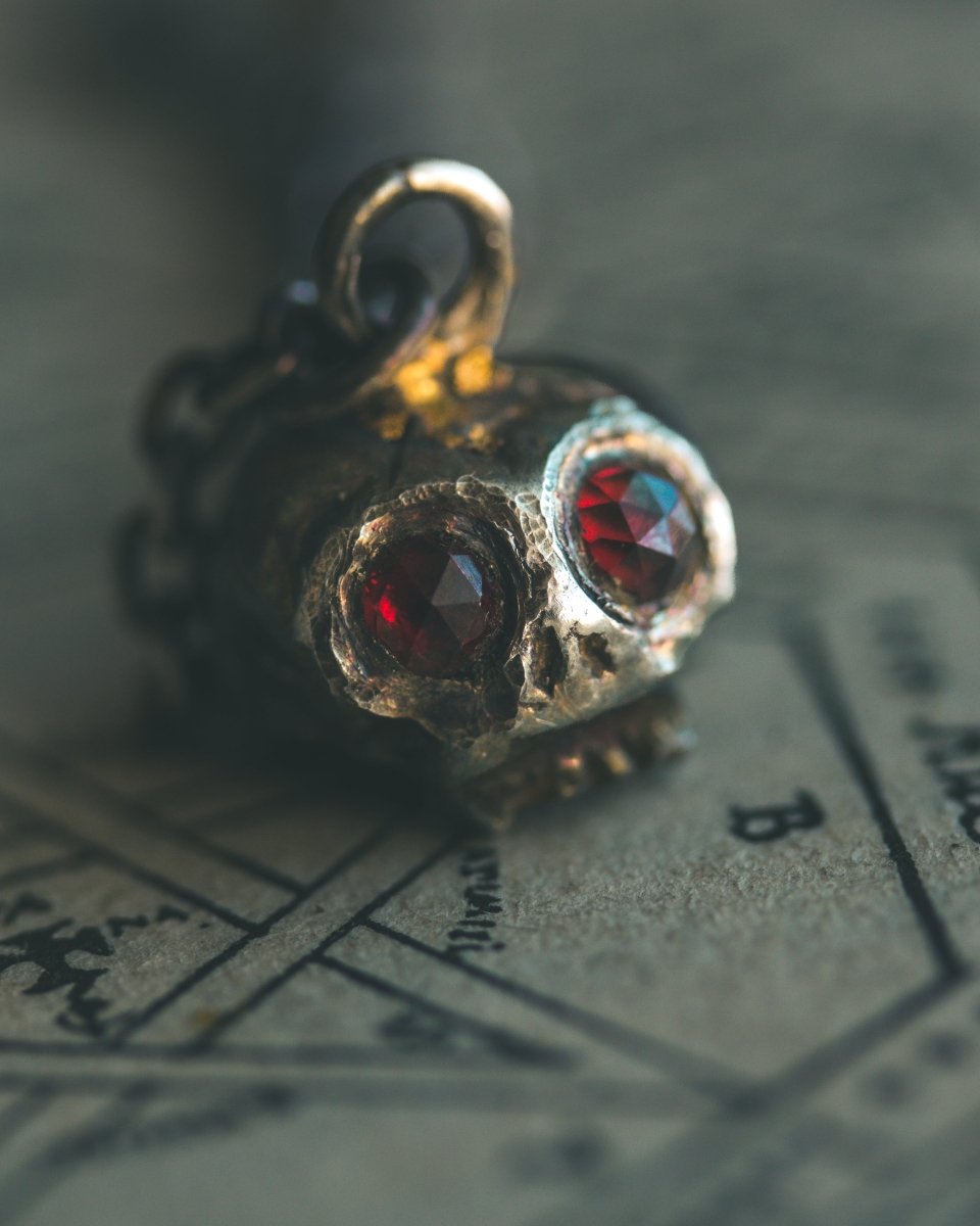 Memento Mori Skull Charm with Almandine Garnet Eyes – Sterling Silver & 23.5K Gold | Talisman of Life, Death, and Deep Transformation - Machinations