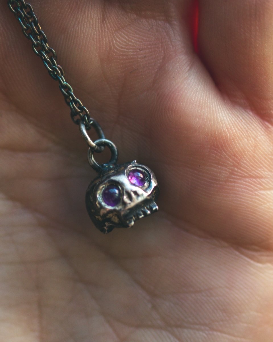 Memento Mori Skull Charm with Amethyst Eyes: A Reflection of Life’s Duality - Machinations
