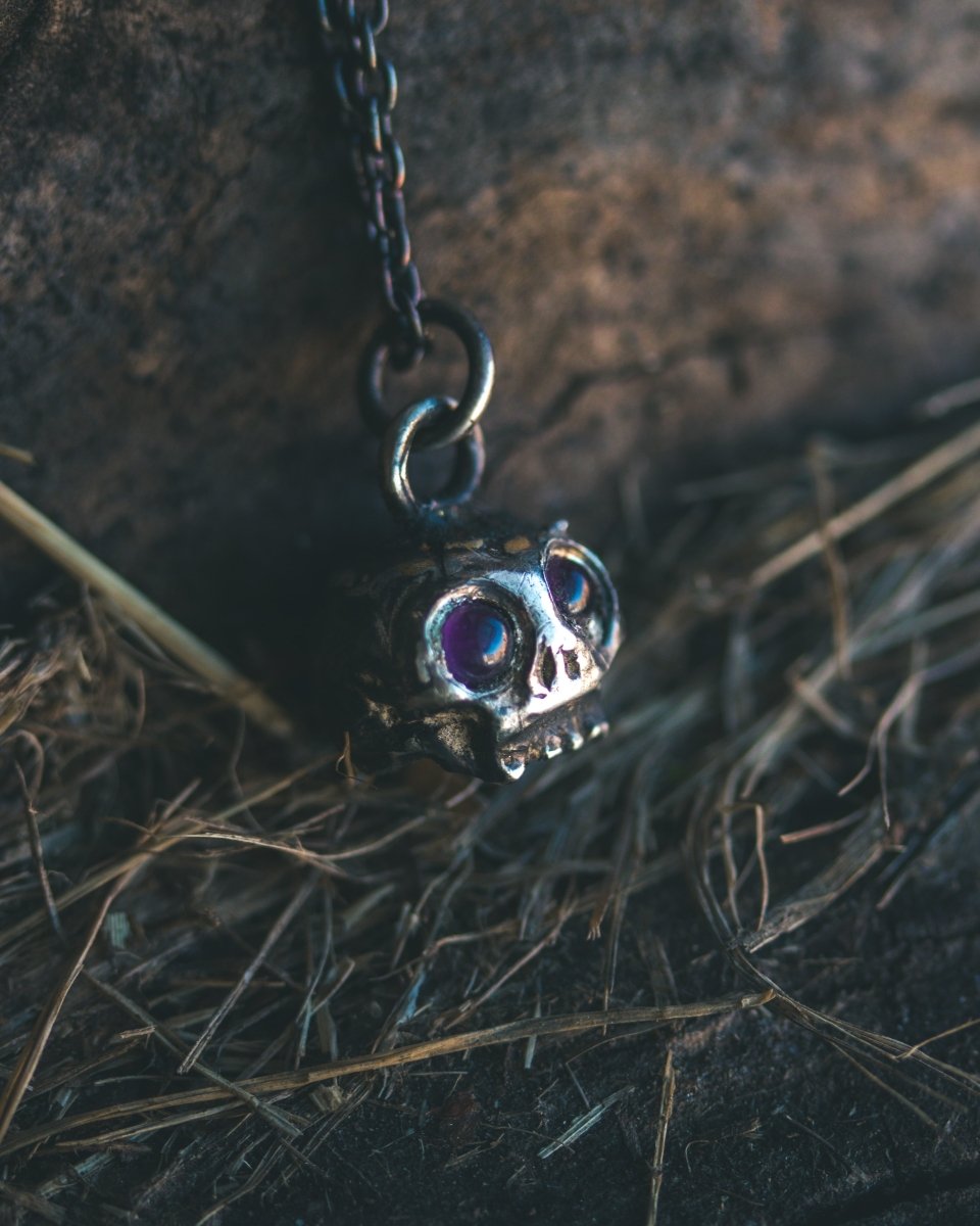 Memento Mori Skull Charm with Amethyst Eyes: A Reflection of Life’s Duality - Machinations