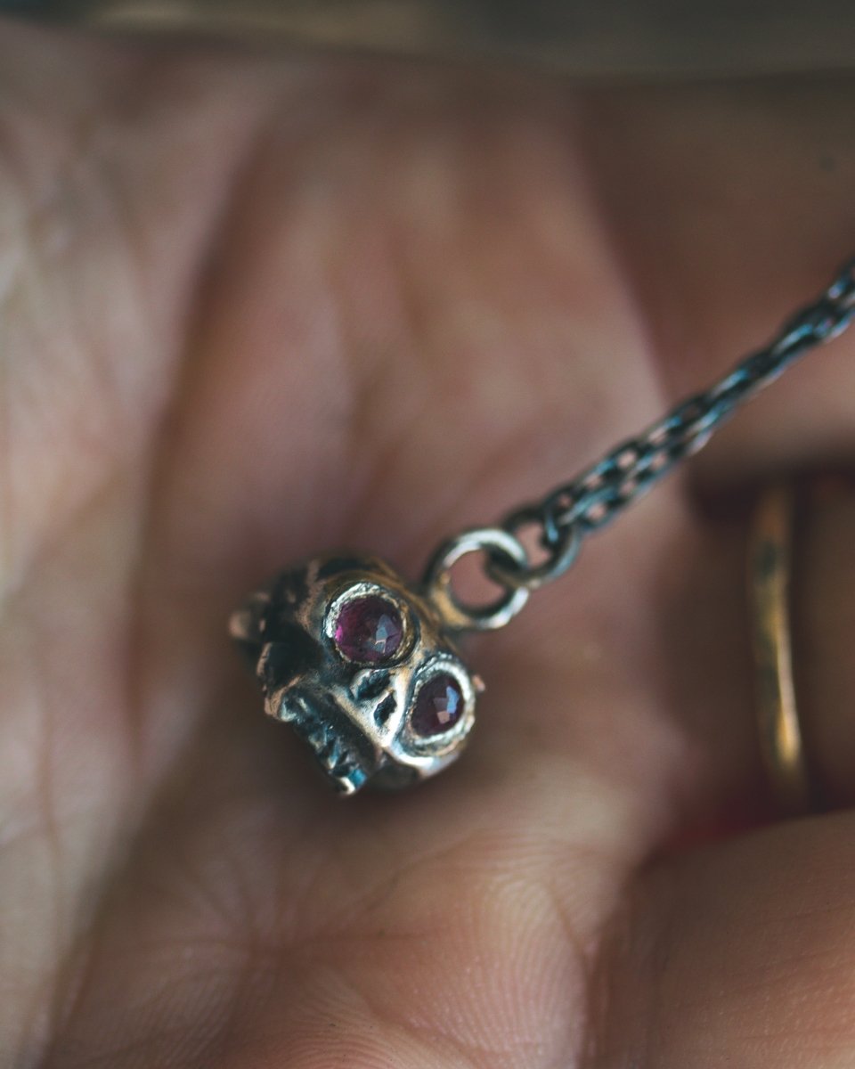 Memento Mori Skull Charm with Rose - Cut Rhodolite Garnet – Sterling Silver & 23.5K Gold | Symbol of Mortality, Strength and Passion - Machinations