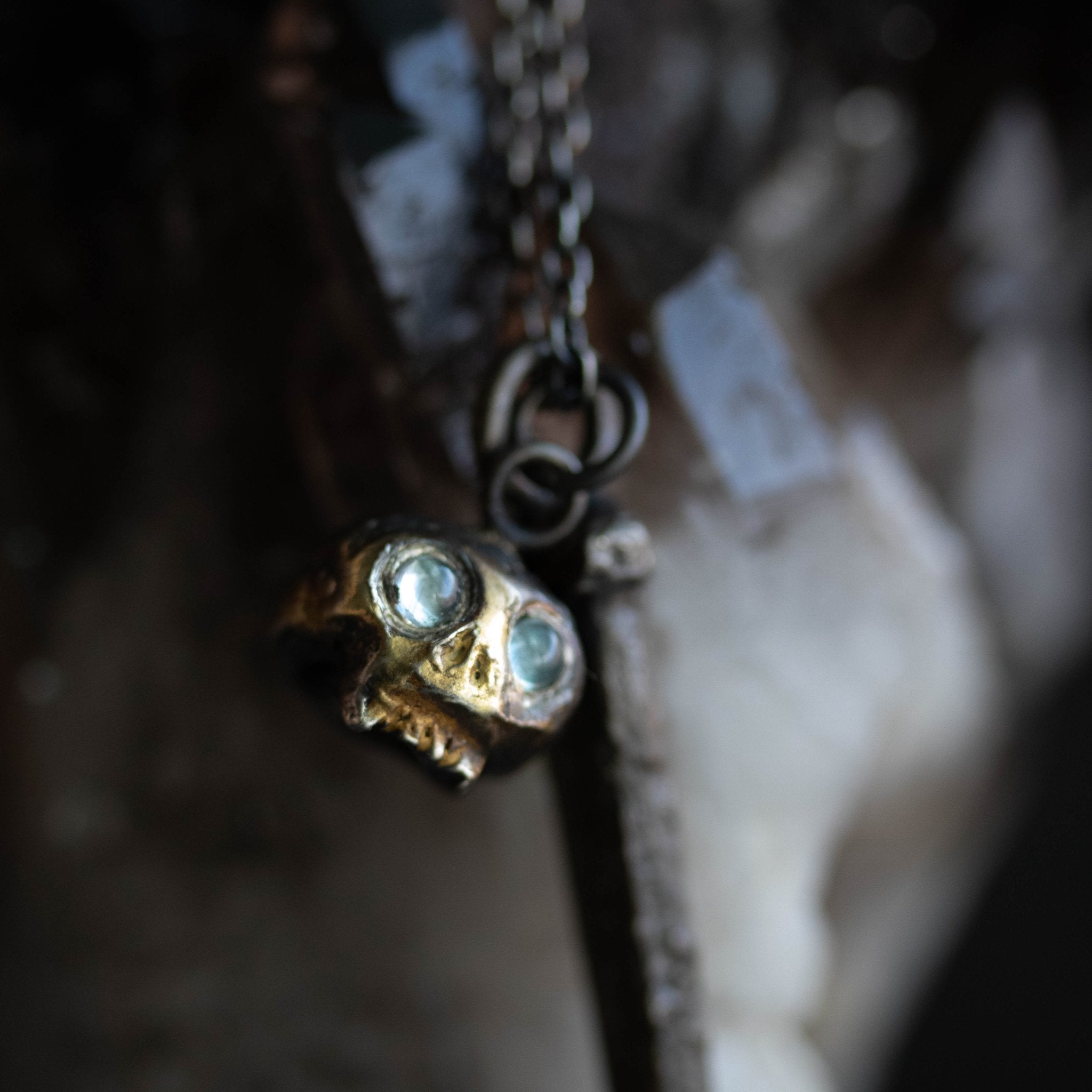 Skull charm with aquamarine eyes - Machinations
